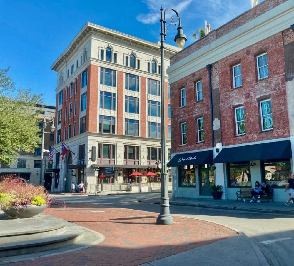 a large brick building with a store on the corner of a street