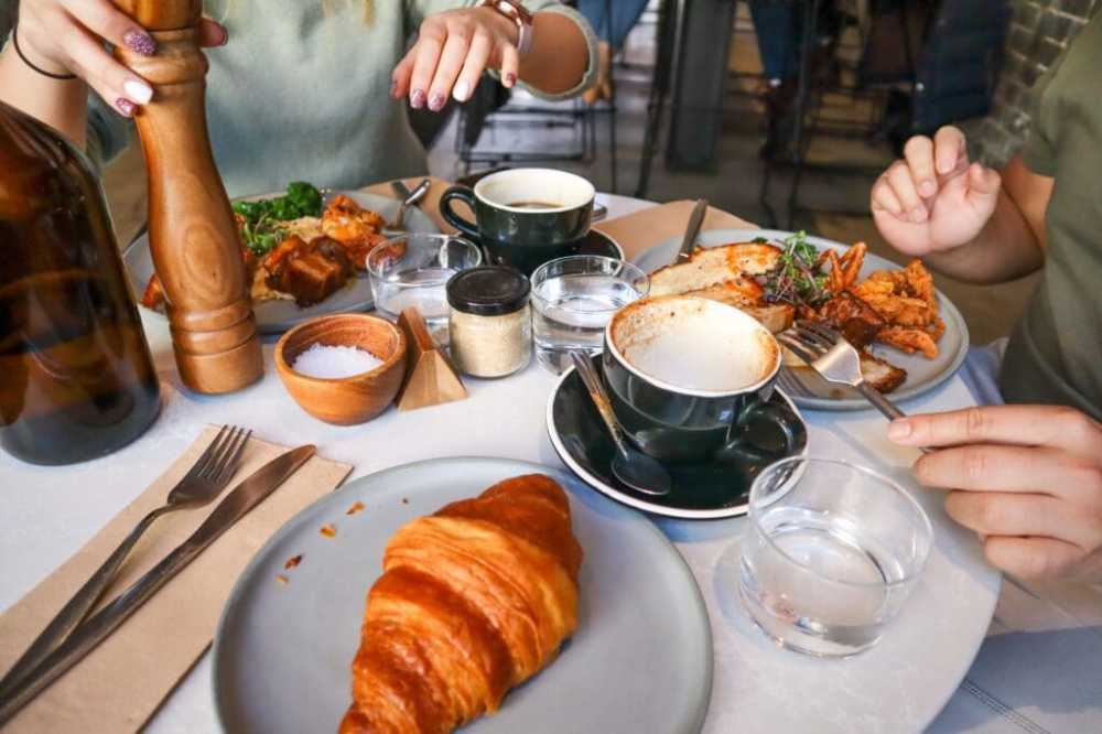 a person sitting at a table with a plate of food