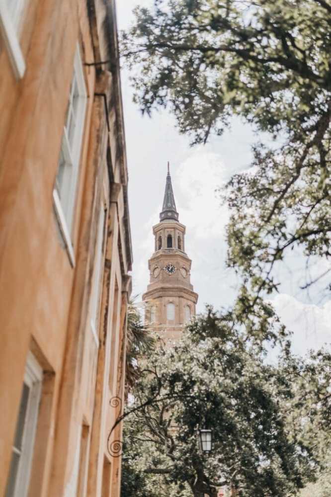 a large tall tower with a clock on the side of a building