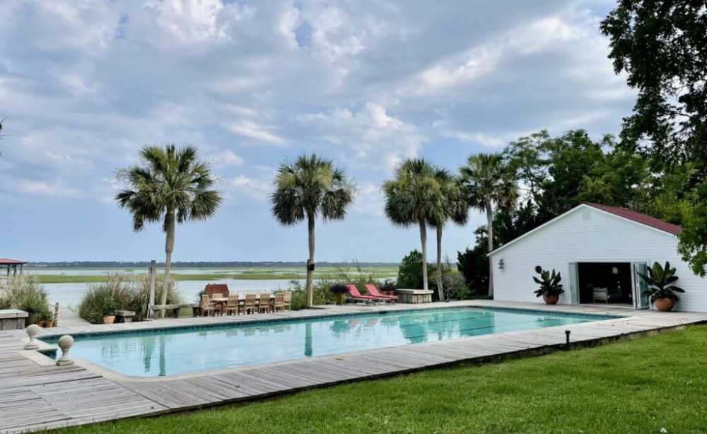 a pool next to a palm tree