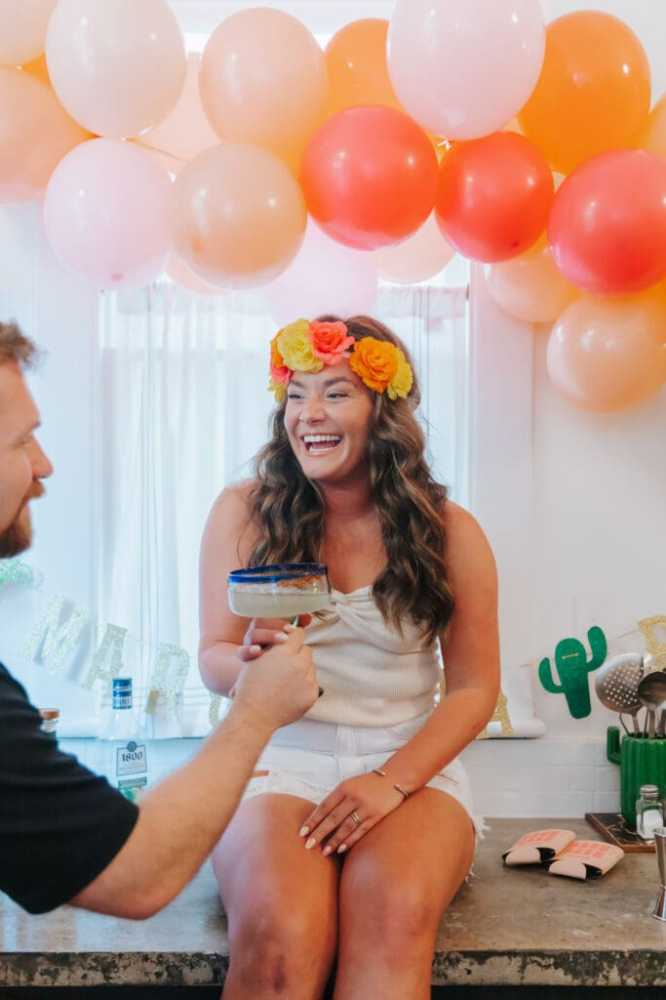 a person sitting at a table with a birthday cake