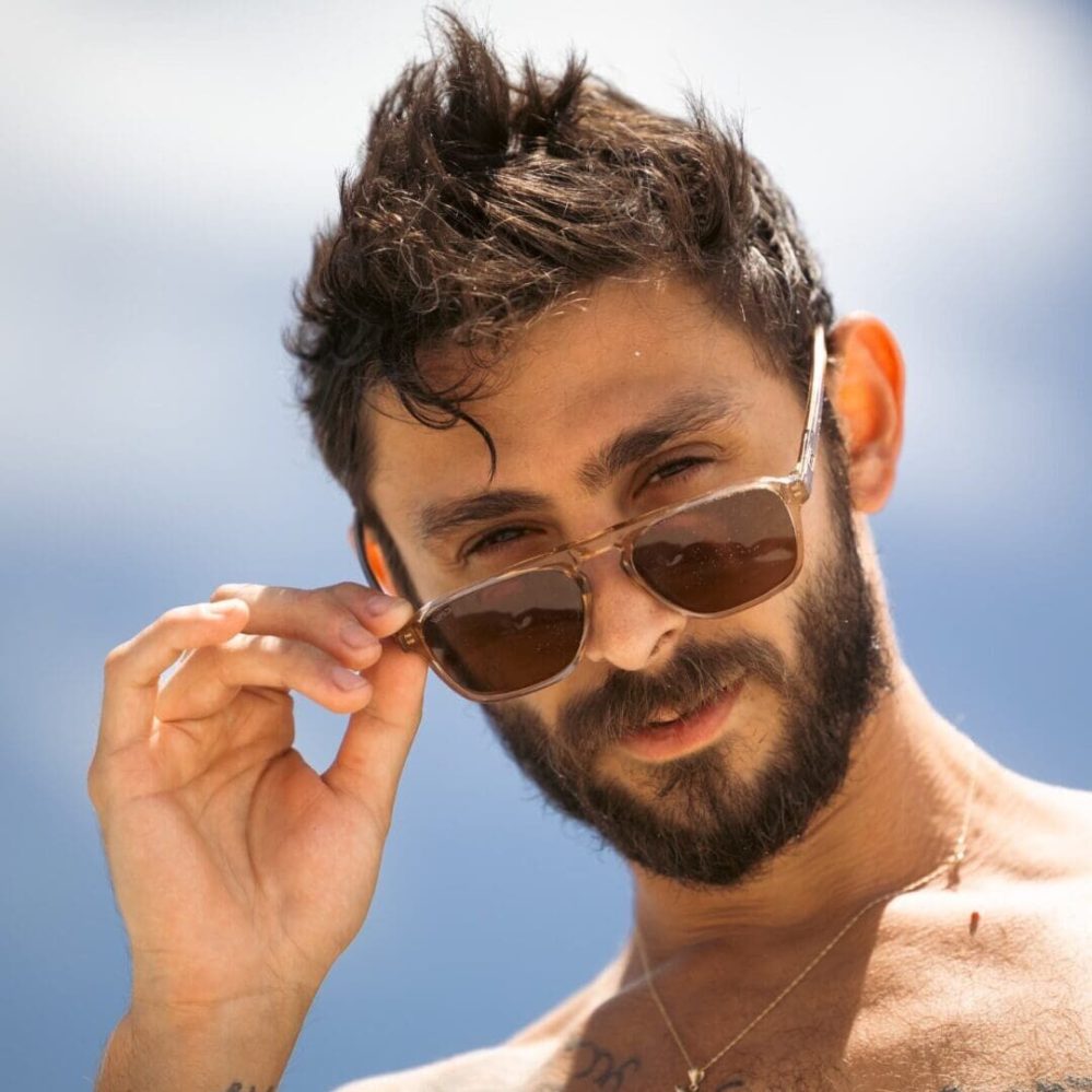 a man wearing glasses talking on a cell phone