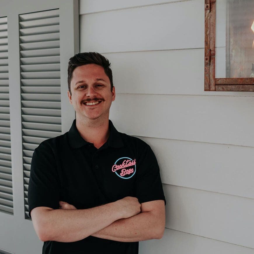 a person standing in front of a window posing for the camera