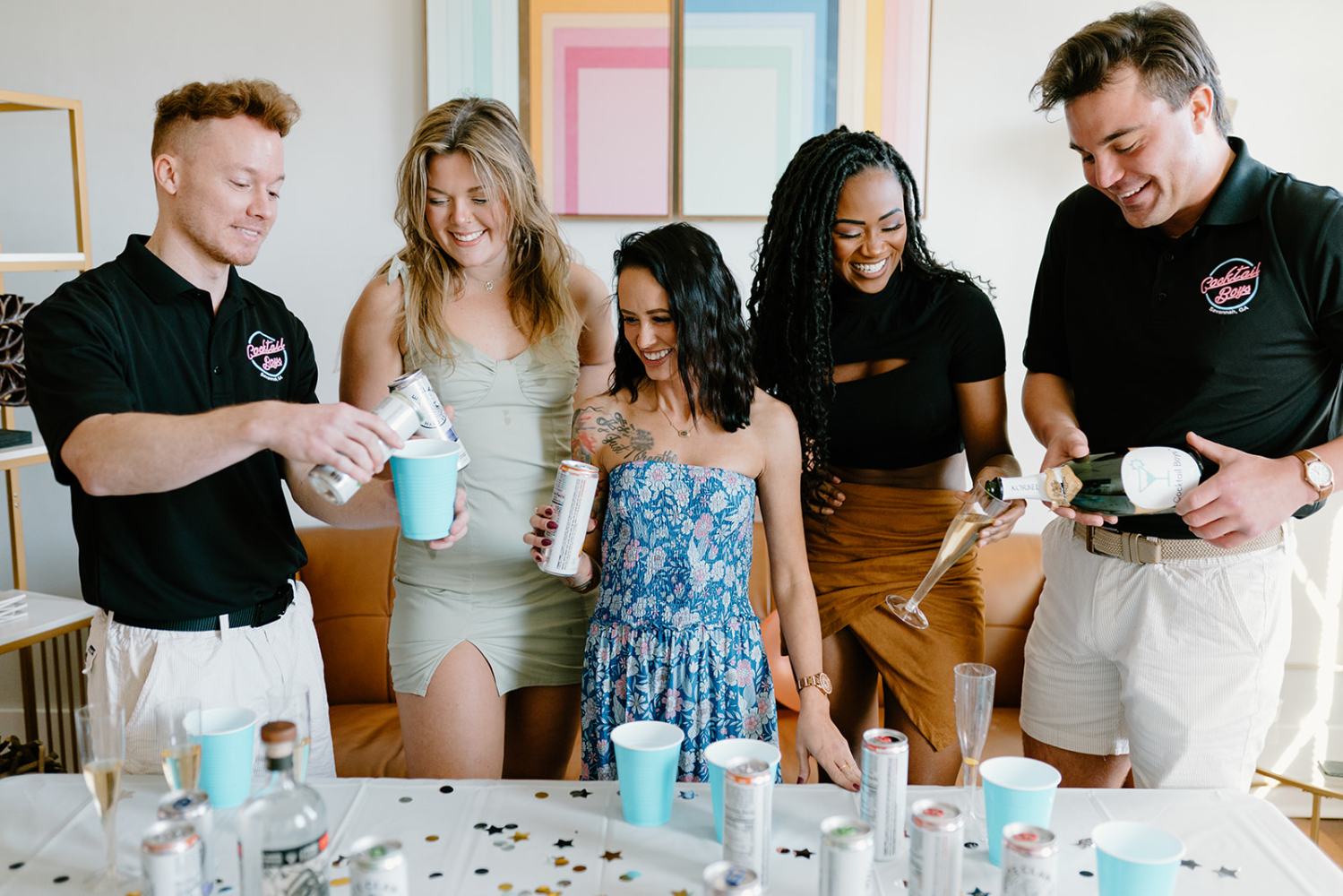 a group of people standing around a table